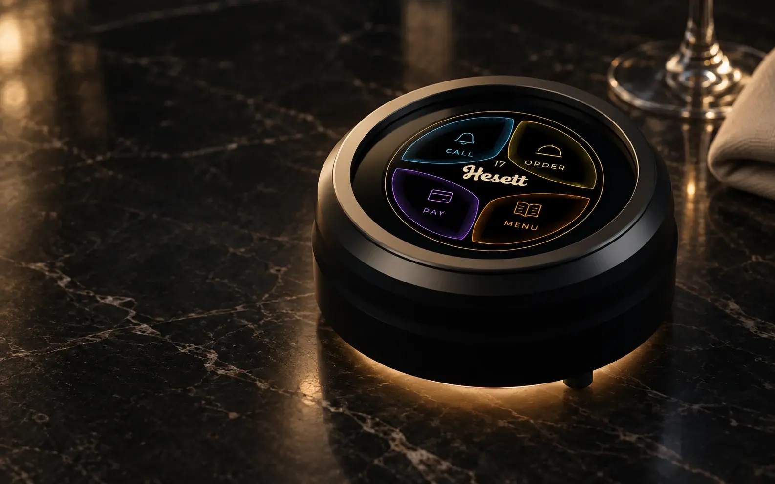 The Hesett table button on a marble restaurant table, screen lit